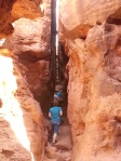 People hiking a narrow passage